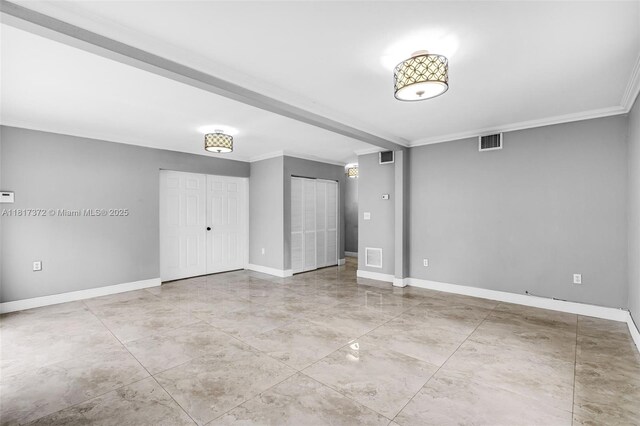 810 E 9th Pl, Hialeah, FL 33010 - unfurnished bedroom featuring ornamental molding, baseboards, and multiple closets
