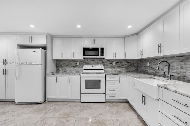 810 E 9th Pl, Hialeah, FL 33010 - kitchen with white appliances, a sink, white cabinetry, tasteful backsplash, and recessed lighting