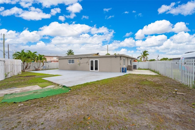 810 E 9th Pl, Hialeah, FL 33010 - rear view of house featuring a patio, french doors, a fenced backyard, and stucco siding