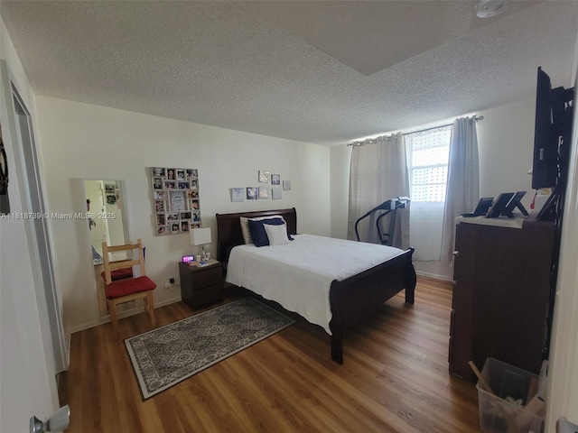 9235 Lagoon Pl Unit 403, Davie, FL 33324 - bedroom featuring a textured ceiling and wood finished floors
