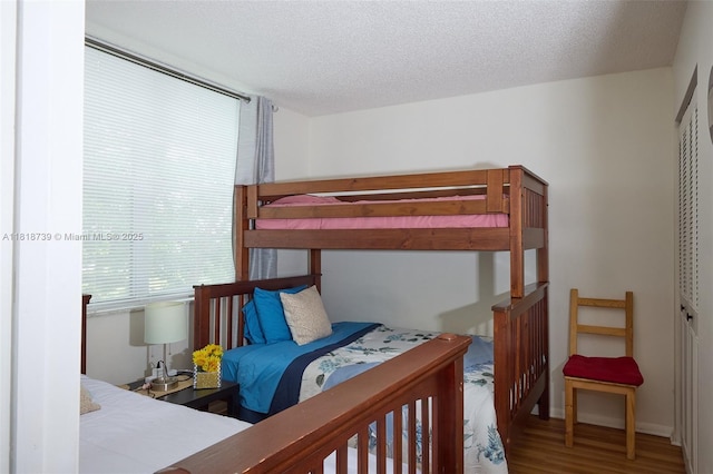 9235 Lagoon Pl Unit 403, Davie, FL 33324 - bedroom with wood finished floors and a textured ceiling