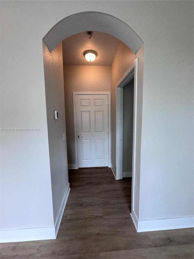 1707 NW 78th Way, Pembroke Pines, FL 33024 - corridor featuring arched walkways and dark wood-style flooring