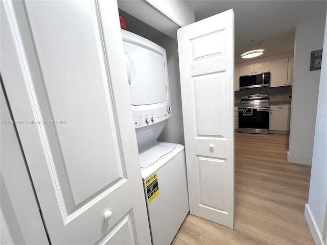 1250 S Miami Ave Unit 2310, Miami, FL 33130 - washroom with stacked washer / drying machine and light wood finished floors