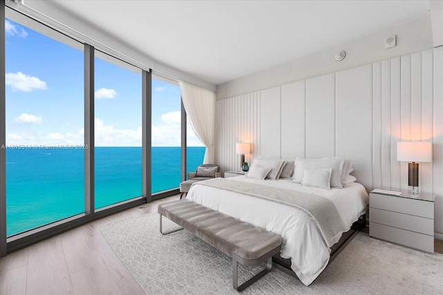 15701 Collins Ave Unit 3101, Sunny Isles Beach, FL 33160 - bedroom with a water view and wood finished floors
