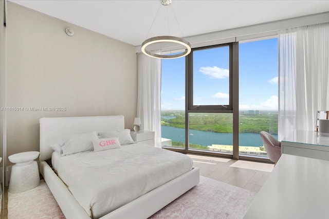 15701 Collins Ave Unit 3101, Sunny Isles Beach, FL 33160 - bedroom featuring a water view and wood finished floors