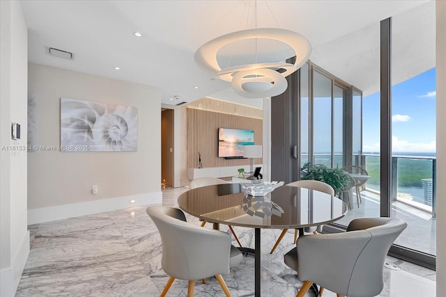 15701 Collins Ave Unit 3101, Sunny Isles Beach, FL 33160 - dining area with marble tiled flooring, a wall of windows, baseboards, and recessed lighting