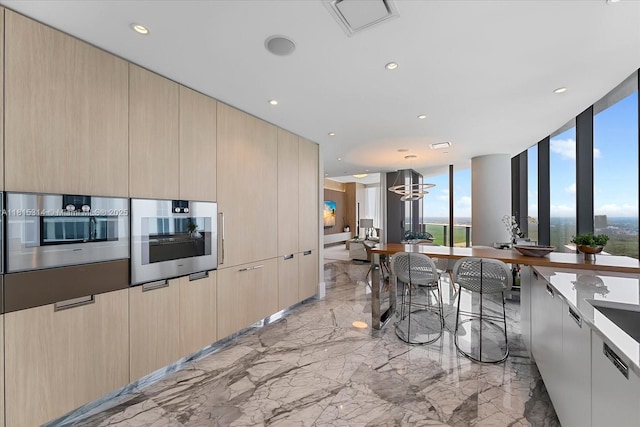 15701 Collins Ave Unit 3101, Sunny Isles Beach, FL 33160 - kitchen with light marble finish floors, modern cabinets, a chandelier, recessed lighting, and decorative light fixtures