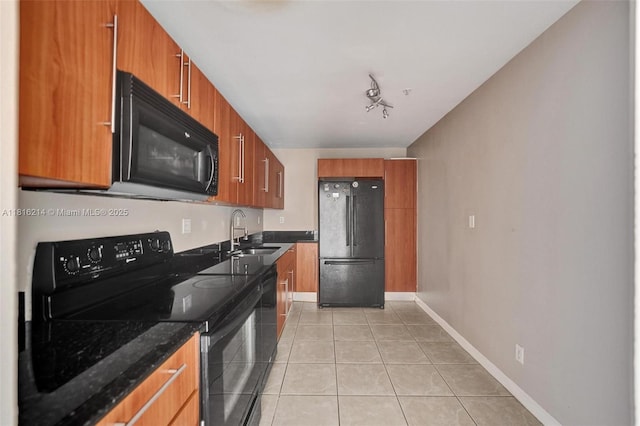 3001 S Ocean Dr Unit 247, Hollywood, FL 33019 - kitchen with black appliances, a sink, light tile patterned flooring, brown cabinetry, and dark stone countertops