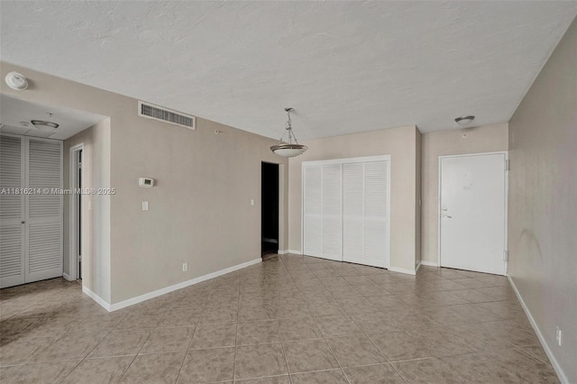 3001 S Ocean Dr Unit 247, Hollywood, FL 33019 - spare room featuring a textured ceiling, light tile patterned flooring, and baseboards