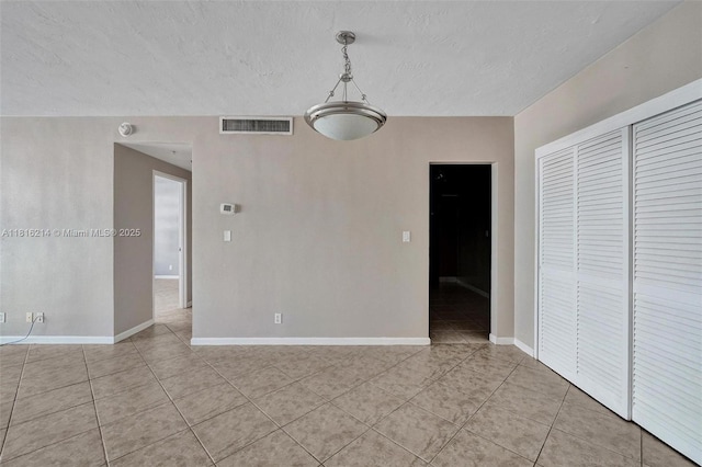 3001 S Ocean Dr Unit 247, Hollywood, FL 33019 - unfurnished dining area featuring light tile patterned floors, a textured ceiling, and baseboards