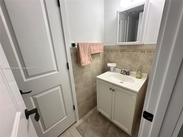 1140 Independence Trl Unit 1140-J, Homestead, FL 33034 - half bathroom featuring vanity, tile walls, tile patterned floors, and wainscoting
