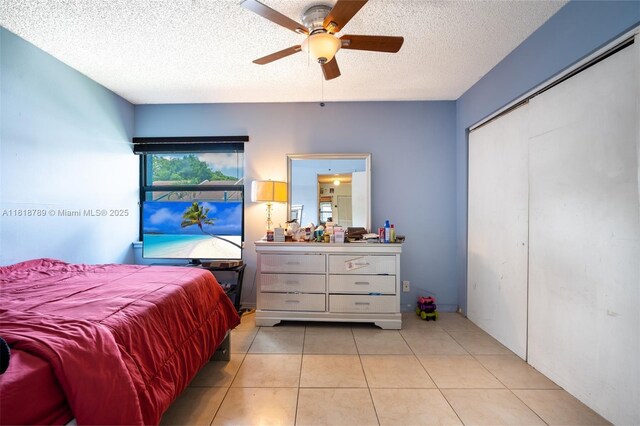 7382 NW 34th St, Lauderhill, FL 33319 - bedroom with a textured ceiling, light tile patterned floors, a ceiling fan, and a closet