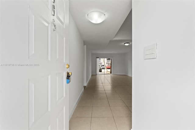 2660 W 76th St Unit 106, Hialeah, FL 33016 - hall featuring light tile patterned flooring and baseboards