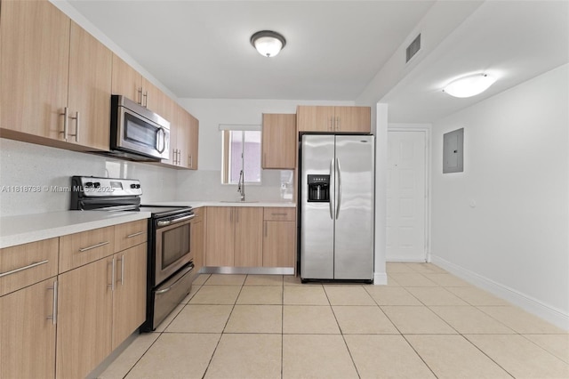 2660 W 76th St Unit 106, Hialeah, FL 33016 - kitchen featuring stainless steel appliances, light countertops, electric panel, a sink, and light brown cabinets