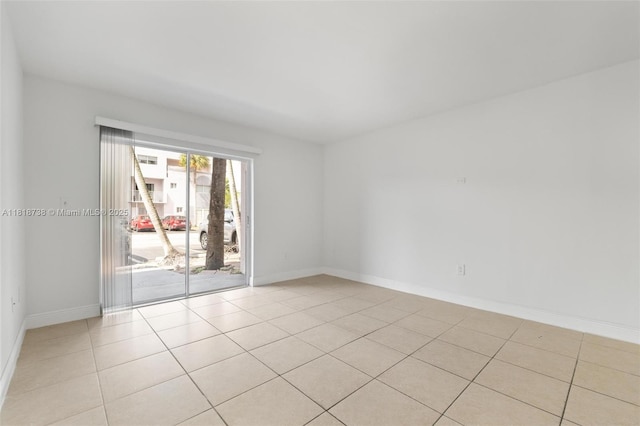 2660 W 76th St Unit 106, Hialeah, FL 33016 - empty room with light tile patterned floors and baseboards