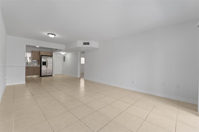 2660 W 76th St Unit 106, Hialeah, FL 33016 - unfurnished living room with light tile patterned floors and baseboards