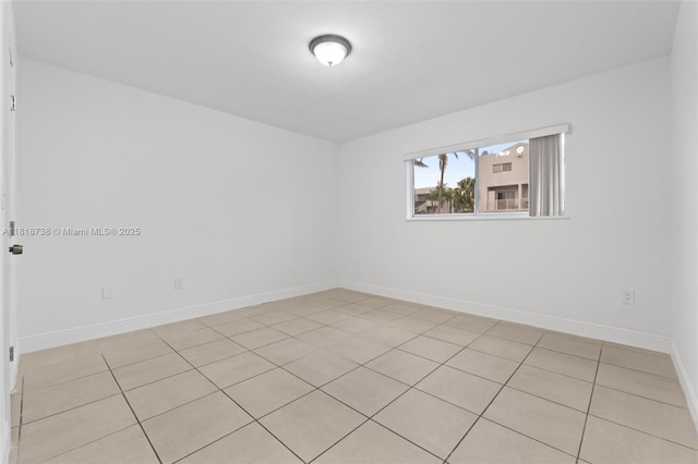 2660 W 76th St Unit 106, Hialeah, FL 33016 - unfurnished room featuring baseboards and light tile patterned floors