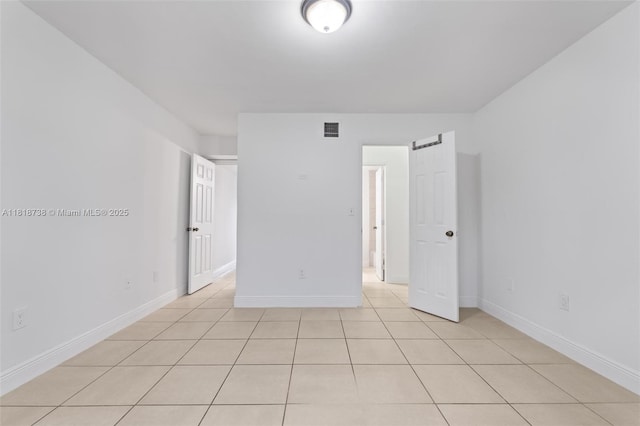 2660 W 76th St Unit 106, Hialeah, FL 33016 - spare room featuring light tile patterned floors and baseboards