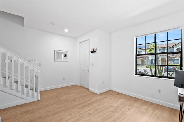9362 W 33rd Ln, Hialeah, FL 33018 - unfurnished living room featuring wood finished floors, baseboards, stairs, and recessed lighting