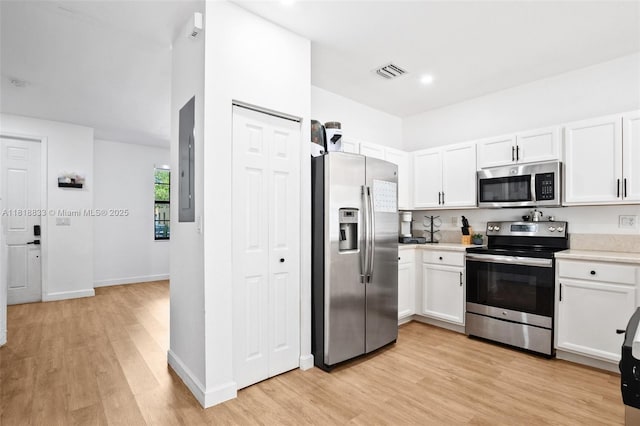 9362 W 33rd Ln, Hialeah, FL 33018 - kitchen with stainless steel appliances, light wood-type flooring, light countertops, and white cabinets
