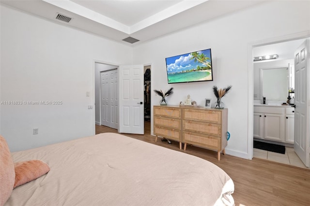 9362 W 33rd Ln, Hialeah, FL 33018 - bedroom with light wood finished floors, ensuite bath, and a spacious closet