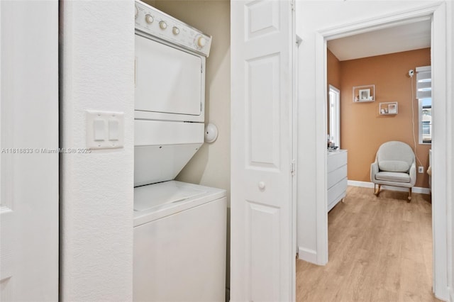 9362 W 33rd Ln, Hialeah, FL 33018 - washroom with estacked washer and dryer, light wood-style flooring, and baseboards