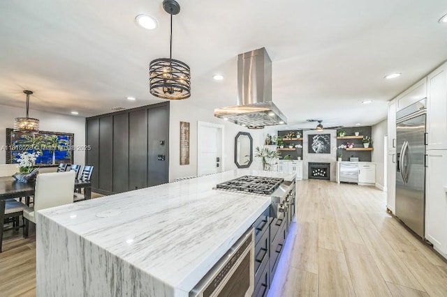 8005 SW 89th St, Miami, FL 33156 - kitchen with ventilation hood, appliances with stainless steel finishes, a chandelier, ceiling fan, and light stone counters