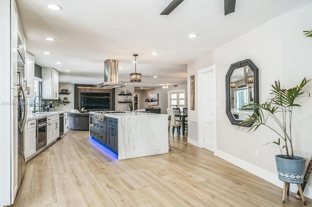 8005 SW 89th St, Miami, FL 33156 - kitchen featuring island exhaust hood, open floor plan, recessed lighting, stainless steel appliances, and light wood-type flooring