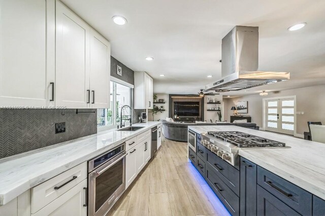 8005 SW 89th St, Miami, FL 33156 - kitchen with appliances with stainless steel finishes, island exhaust hood, open floor plan, white cabinetry, and recessed lighting