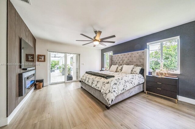 8005 SW 89th St, Miami, FL 33156 - bedroom featuring access to exterior, light wood-style floors, an accent wall, and a ceiling fan