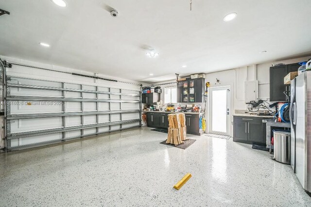 8005 SW 89th St, Miami, FL 33156 - garage with electric panel, recessed lighting, and freestanding refrigerator