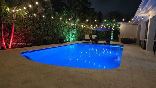 8005 SW 89th St, Miami, FL 33156 - pool at night featuring a patio and an outdoor pool