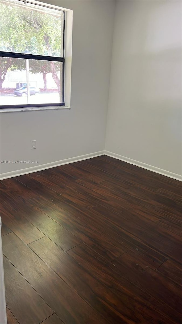 9808 Hammocks Blvd Unit 203-23, Miami, FL 33196 - empty room featuring baseboards and dark wood-style floors