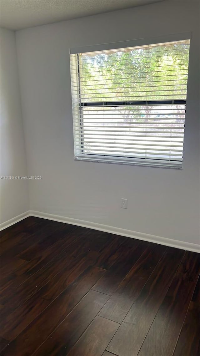 9808 Hammocks Blvd Unit 203-23, Miami, FL 33196 - empty room with dark wood-style floors and baseboards
