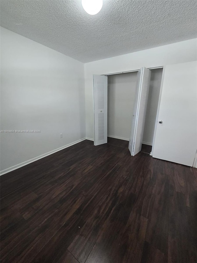 9808 Hammocks Blvd Unit 203-23, Miami, FL 33196 - unfurnished bedroom with dark wood-type flooring and baseboards