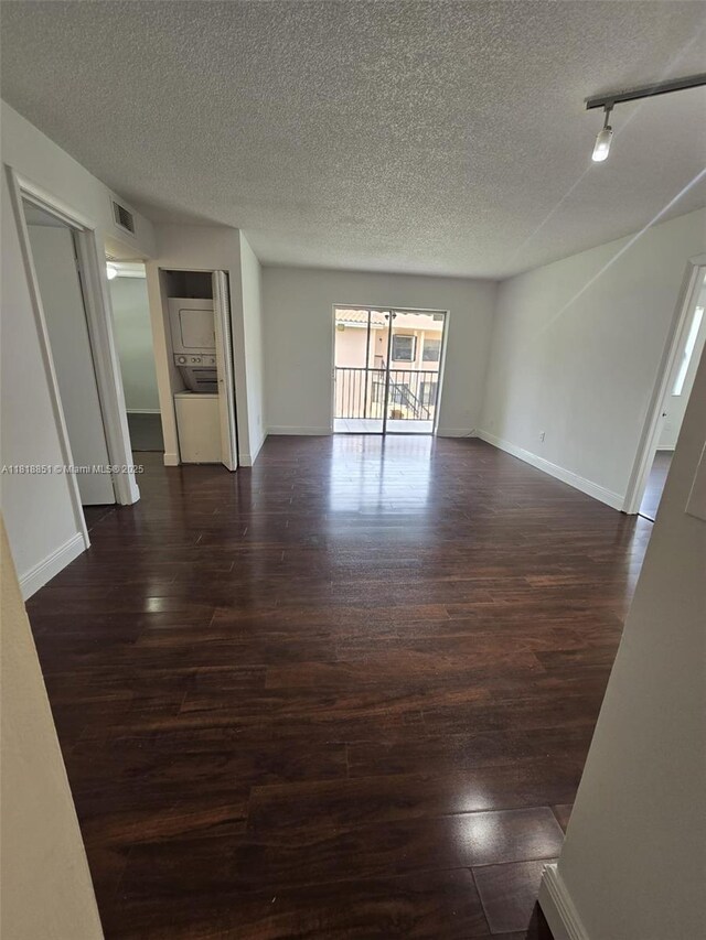 9808 Hammocks Blvd Unit 203-23, Miami, FL 33196 - spare room featuring dark wood finished floors, a textured ceiling, baseboards, and rail lighting