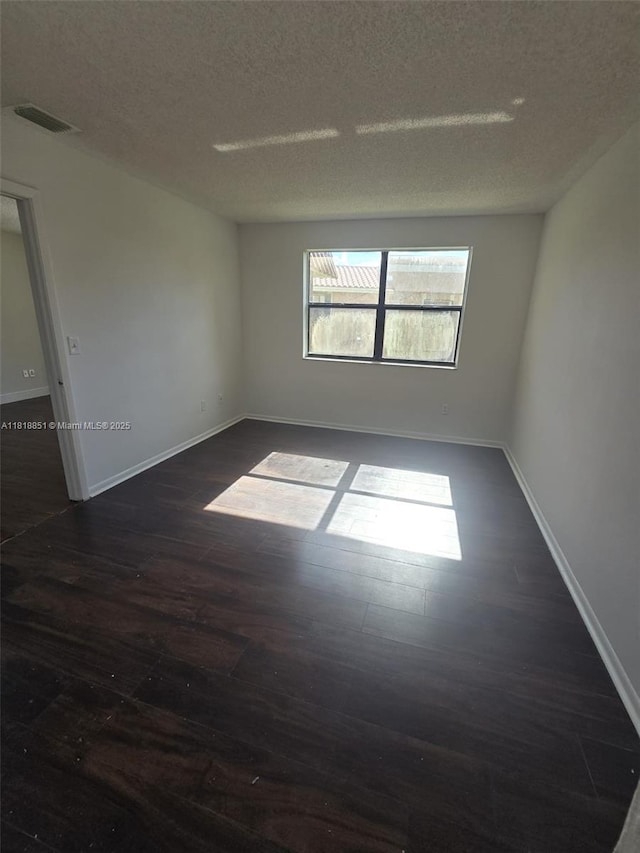 9808 Hammocks Blvd Unit 203-23, Miami, FL 33196 - spare room featuring dark wood finished floors, a textured ceiling, and baseboards