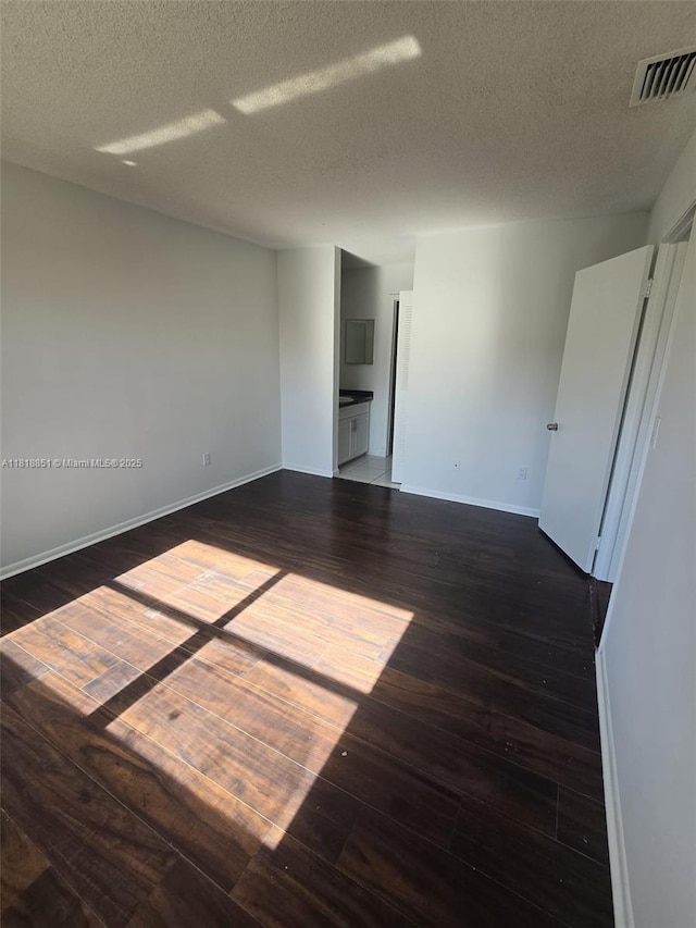 9808 Hammocks Blvd Unit 203-23, Miami, FL 33196 - empty room featuring dark wood-style floors, a textured ceiling, and baseboards