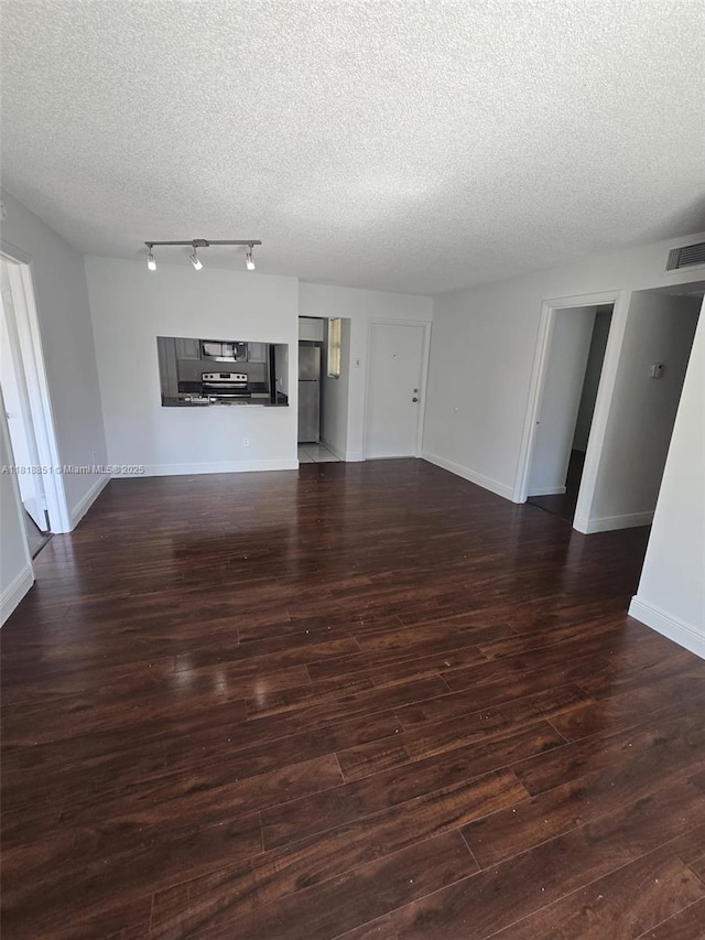 9808 Hammocks Blvd Unit 203-23, Miami, FL 33196 - unfurnished living room featuring a textured ceiling, wood finished floors, and baseboards