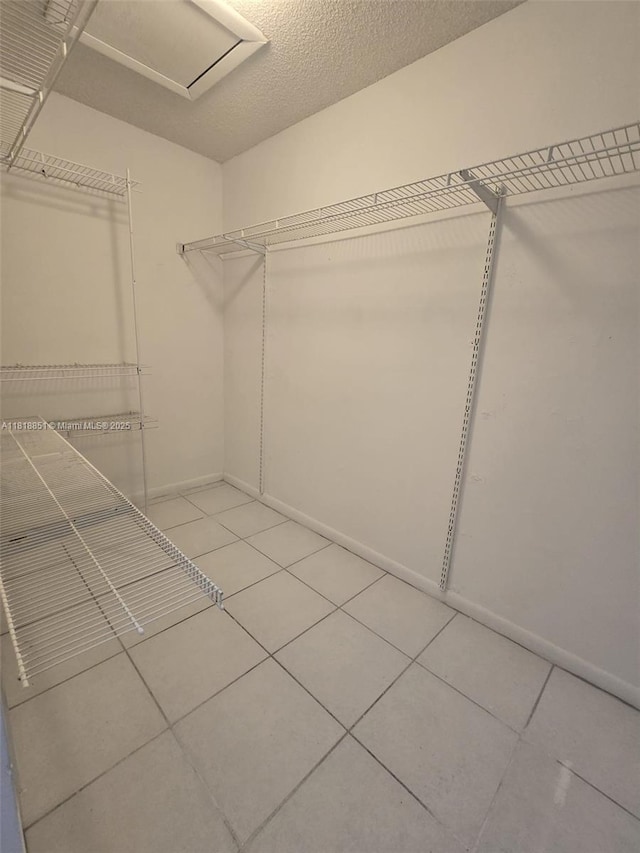 9808 Hammocks Blvd Unit 203-23, Miami, FL 33196 - spacious closet with light tile patterned floors and attic access