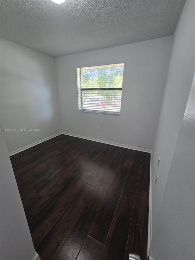 9808 Hammocks Blvd Unit 203-23, Miami, FL 33196 - spare room with dark wood-type flooring, a textured ceiling, and baseboards