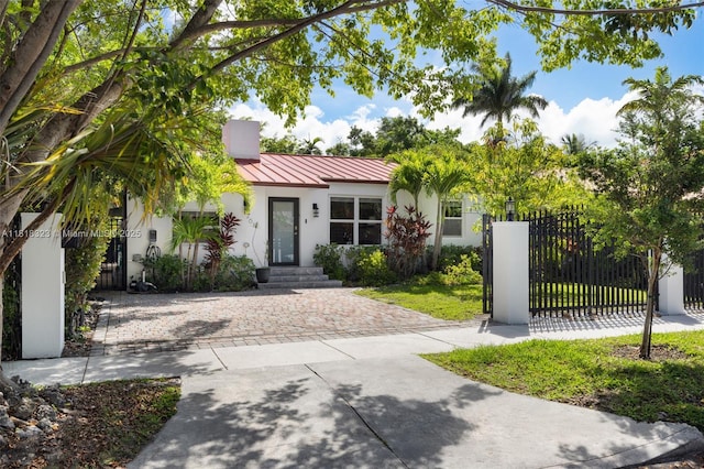 261 SW 30th Rd, Miami, FL 33129 - ranch-style house with stucco siding, a standing seam roof, driveway, and metal roof