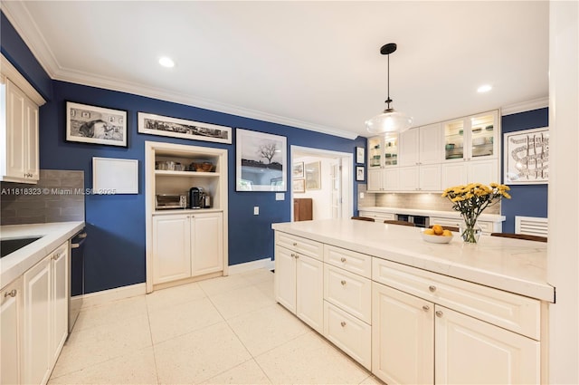 261 SW 30th Rd, Miami, FL 33129 - kitchen with backsplash, crown molding, white cabinets, light countertops, and glass insert cabinets