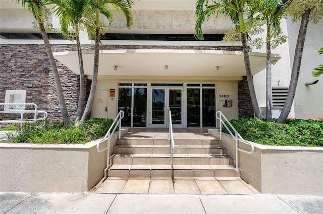 2400 SW 27th Ave Unit 402, Miami, FL 33145 - doorway to property featuring french doors and stucco siding