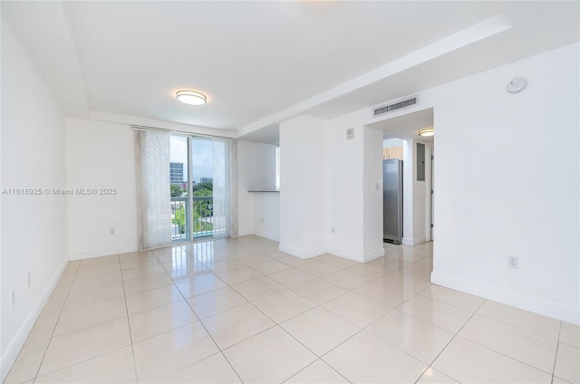 2400 SW 27th Ave Unit 402, Miami, FL 33145 - spare room featuring light tile patterned flooring and a smoke detector