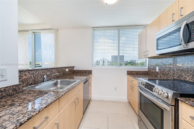2400 SW 27th Ave Unit 402, Miami, FL 33145 - kitchen featuring appliances with stainless steel finishes, light brown cabinets, and dark stone countertops