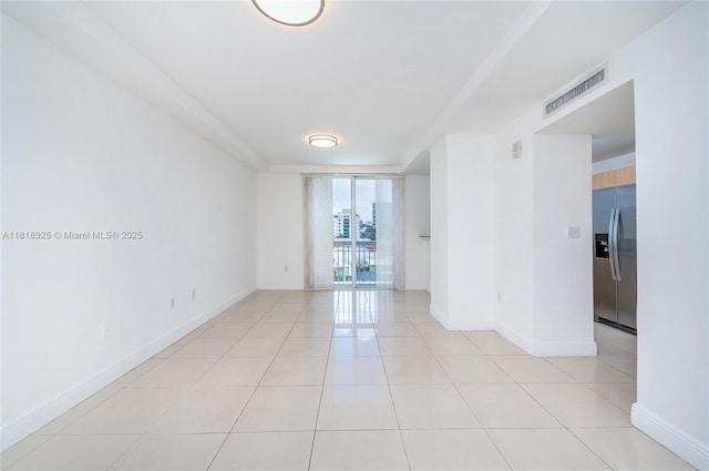 2400 SW 27th Ave Unit 402, Miami, FL 33145 - spare room with baseboards and light tile patterned floors