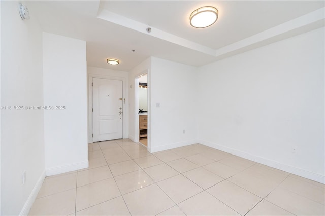 2400 SW 27th Ave Unit 402, Miami, FL 33145 - empty room with light tile patterned flooring, a smoke detector, and a raised ceiling