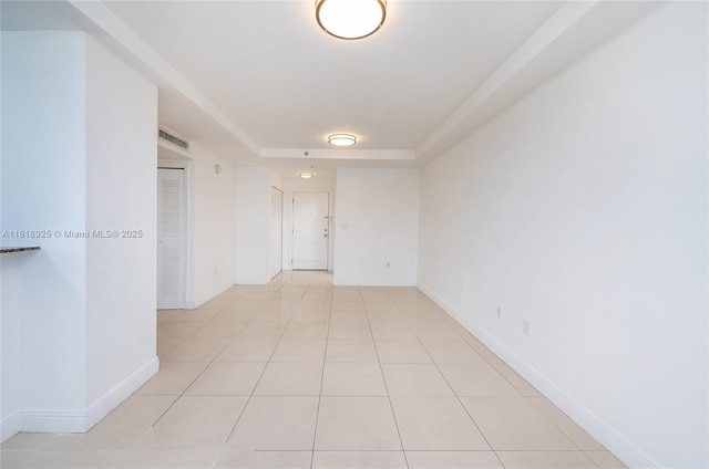 2400 SW 27th Ave Unit 402, Miami, FL 33145 - unfurnished room with light tile patterned floors and a tray ceiling