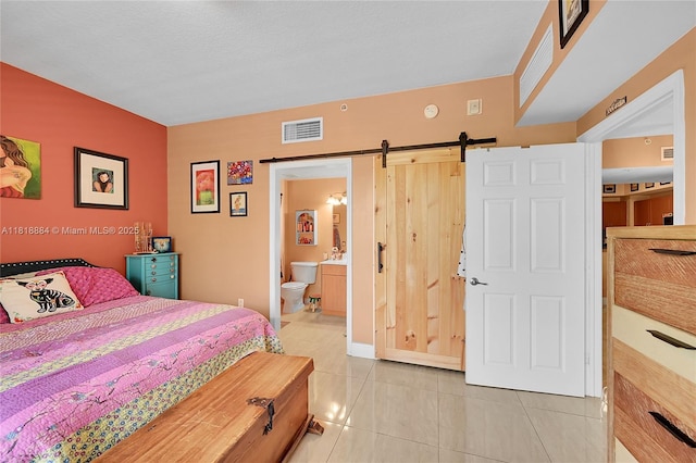 8440 SW 8th St Unit 306A, Miami, FL 33144 - bedroom featuring a barn door, light tile patterned floors, and ensuite bathroom